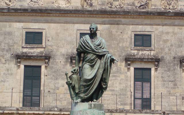 Bronze statue in front of a neoclassical building in Corfu Town