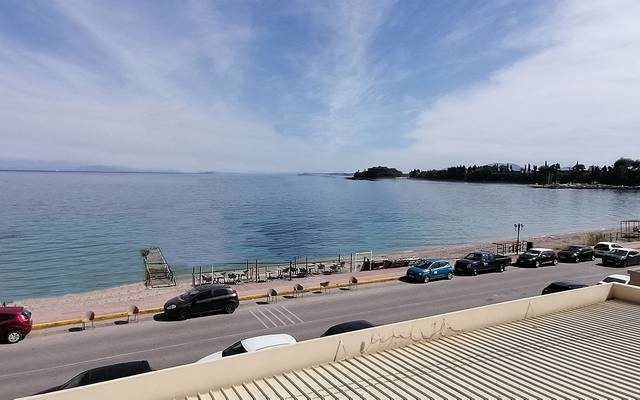 Seafront road curving along a calm bay